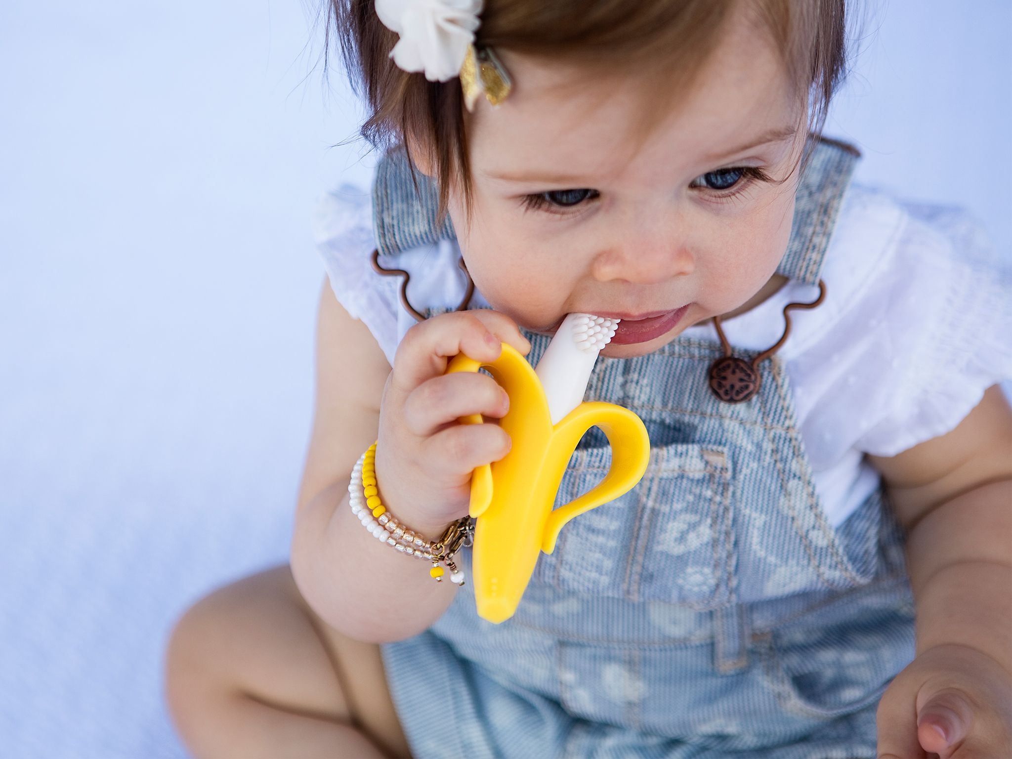 Girl uses yellow Baby Banana Brush